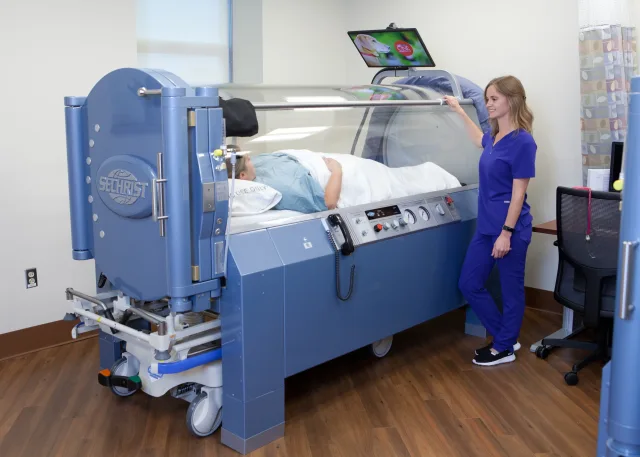 Nurse supervising a patient inside a medical-grade monoplace hyperbaric chamber